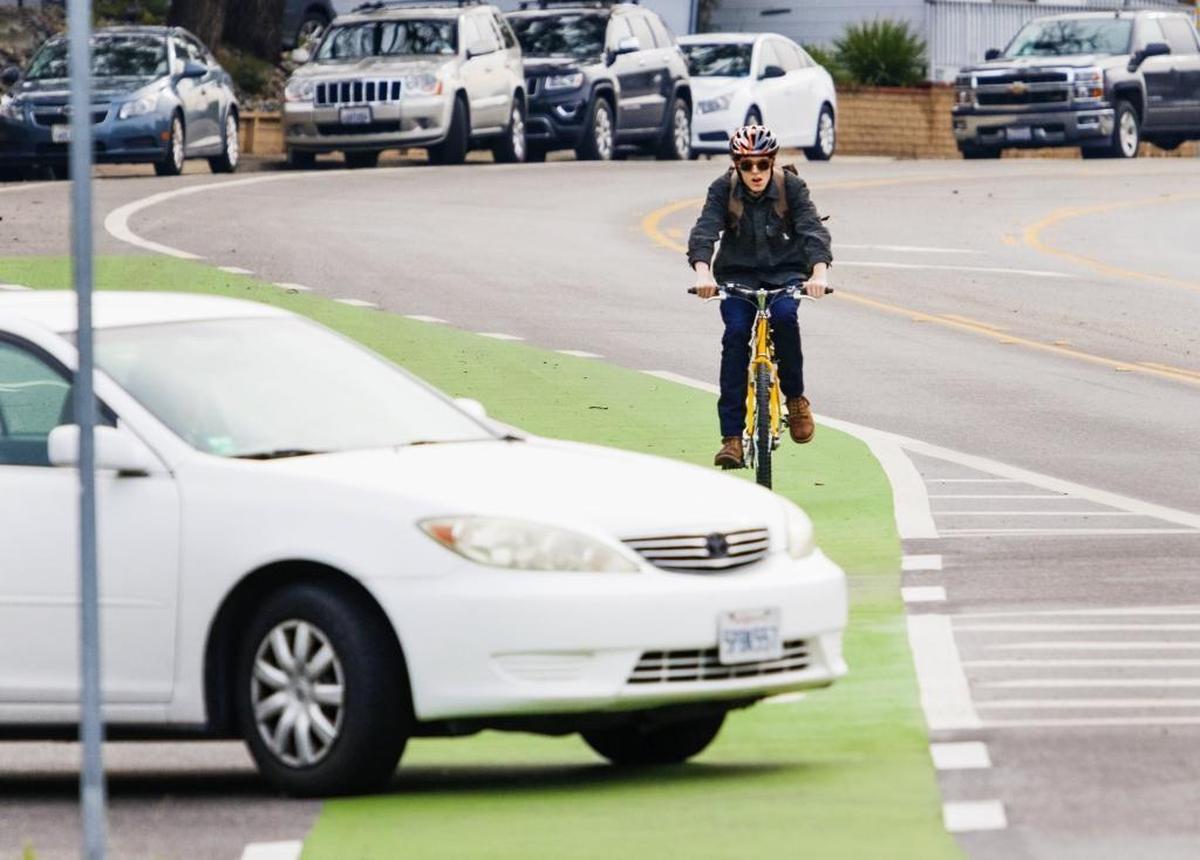 A cyclist bikes towards Cal Poly in the green bike lane along California Boulevard, which was added to increase safety for bicyclists. Councilman Dan Rivoire has worked to improve bike safety in the city. He won’t seek re-election this year.