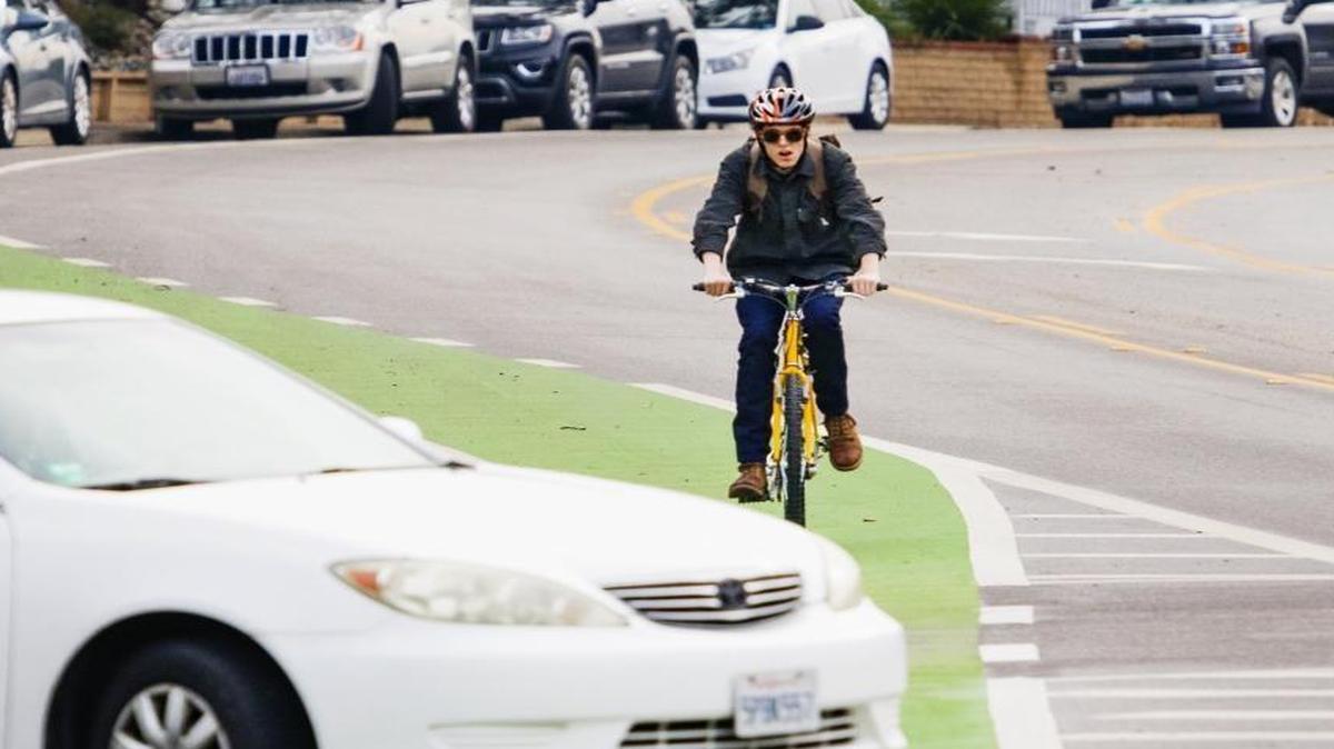 A cyclist bikes towards Cal Poly in the green bike lane along California Boulevard, which was added to increase safety for bicyclists. Councilman Dan Rivoire has worked to improve bike safety in the city. He won’t seek re-election this year.