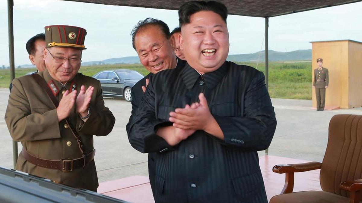 FILE - In this undated file photo distributed on Sept. 16, 2017, by the North Korean government, North Korean leader Kim Jong Un, right, celebrates what was said to be the test launch of an intermediate range Hwasong-12 missile at an undisclosed location in North Korea. North Korea says it will never give up its nuclear weapons as long as the United States and its allies continue their âblackmail and war drillsâ at its doorstep. Independent journalists were not given access to cover the event depicted in this image distributed by the North Korean government. The content of this image is as provided and cannot be independently verified.