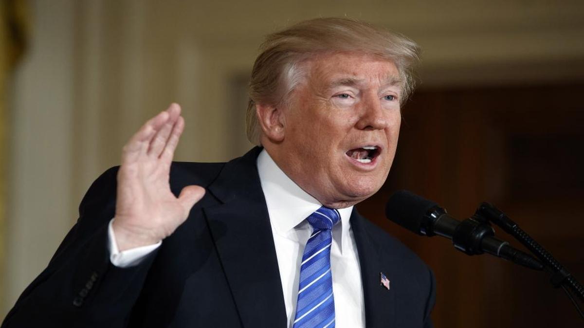President Donald Trump speaks in the East Room of the White House in Washington.