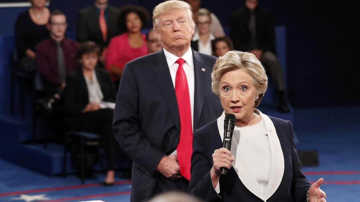 In this Oct. 9, 2016 photo, Democratic presidential nominee Hillary Clinton, right, speaks as Republican presidential nominee Donald Trump listens during the second presidential debate at Washington University in St. Louis, Sunday, Oct. 9, 2016.