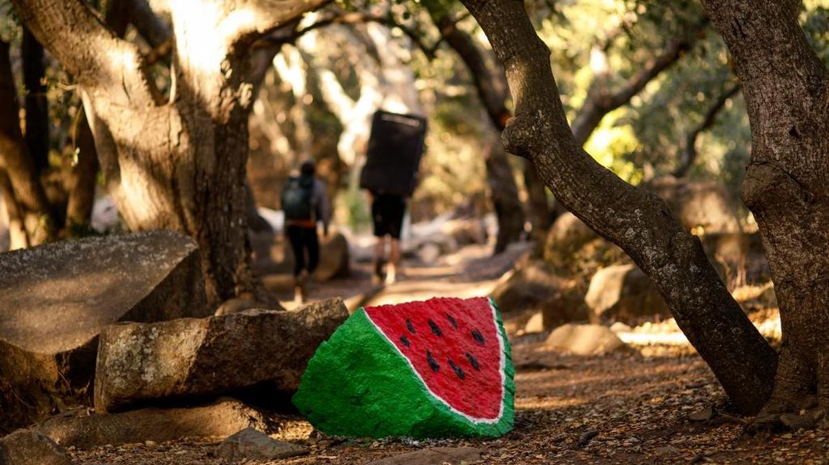 A rock along the Bishop Peak trail near Highland Drive in San Luis Obispo has again been painted to look like a giant slice of watermelon.