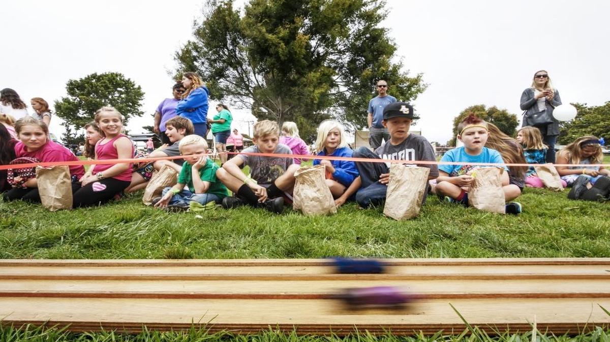 Spectators watch the annual Summer Playground Pinewood Derby Race at Elm Street Park in Arroyo Grande in August 2016.