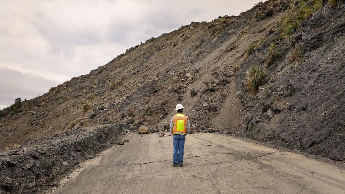 Bret Haney, construction inspector with Caltrans, looks at the south side of the Mud Creek Slide on Highway 1.