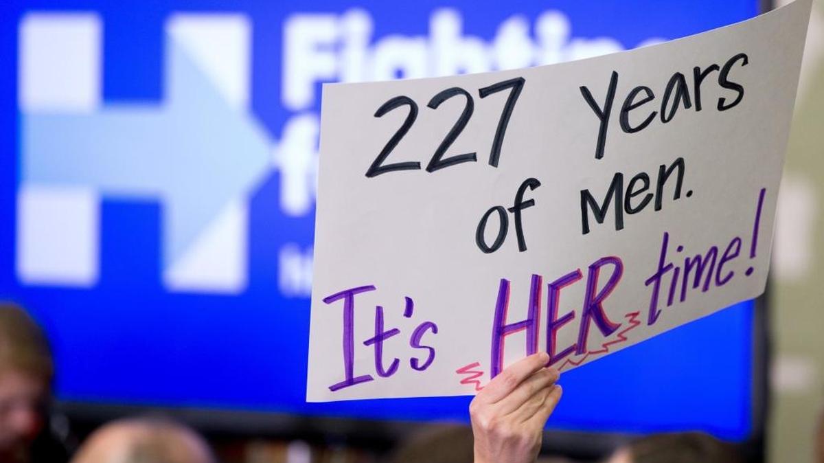 In this Saturday, Jan. 30, 2016 file photo, a member of the audience holds a sign that reads, "227 Years of Men. It's HER Time!" during a rally for Democratic presidential candidate Hillary Clinton at Washington High School in Cedar Rapids, Iowa. It's a complicated time for gender relations in the U.S., as the campaign pitting Clinton against Republican presidential nominee Donald Trump has underscored.