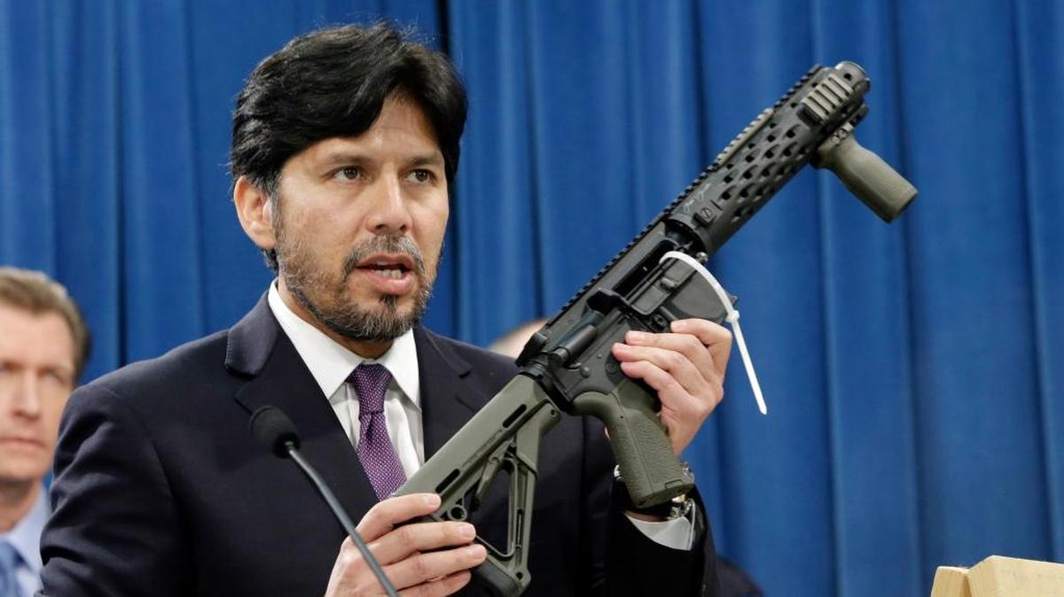 In this Jan. 13, 2014 file photo, California State Sen. Kevin de Leon, D-Los Angeles, displays a homemade fully automatic rifle, confiscated by the Department of Justice, at the Capitol in Sacramento, Calif.