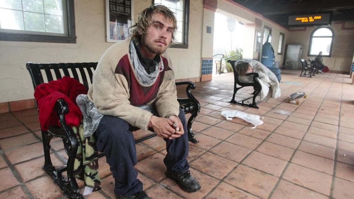 Brandon Michael Williams found shelter from the rain in the train station on Jan. 18. A large group of homeless residents have set up camp along Highway 1 and the railroad tracks in Grover Beach.