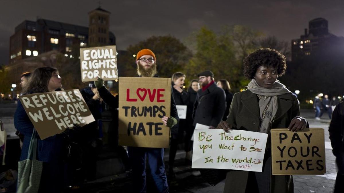 In this Tuesday, Nov. 15 photo, protestors hold banners during a protest against President-elect Donald Trump in Washington Square Park in New York.
