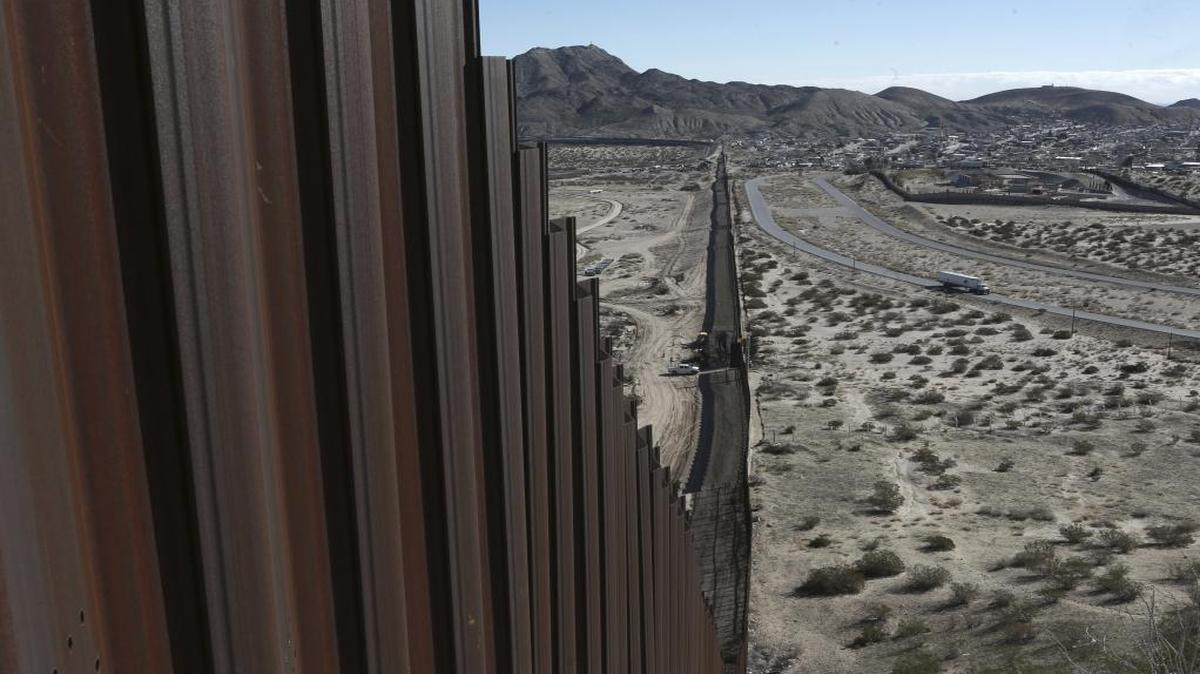 This Jan. 25, 2017, file photo shows a truck driving near the Mexico-US border fence, on the Mexican side, separating the towns of Anapra, Mexico and Sunland Park, New Mexico.