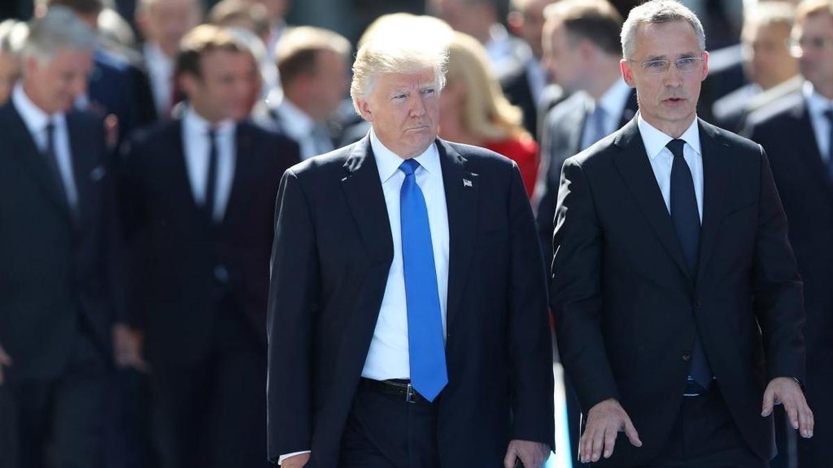 U.S. President Donald Trump, left, and with NATO Secretary General Jens Stoltenberg in front of other world leaders at NATO headquarters in Brussels, Belgium, on May 25, 2017.