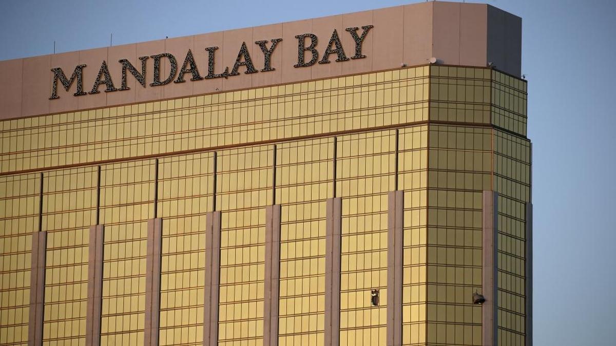 FILE - In this Monday, Oct. 2, 2017 file photo, drapes billow out of broken windows at the Mandalay Bay resort and casino on the Las Vegas Strip, following a deadly shooting at a music festival in Las Vegas. Police who have yet to find Stephen Paddock's motive for the massacre said Friday, that they will enlist the public's help.