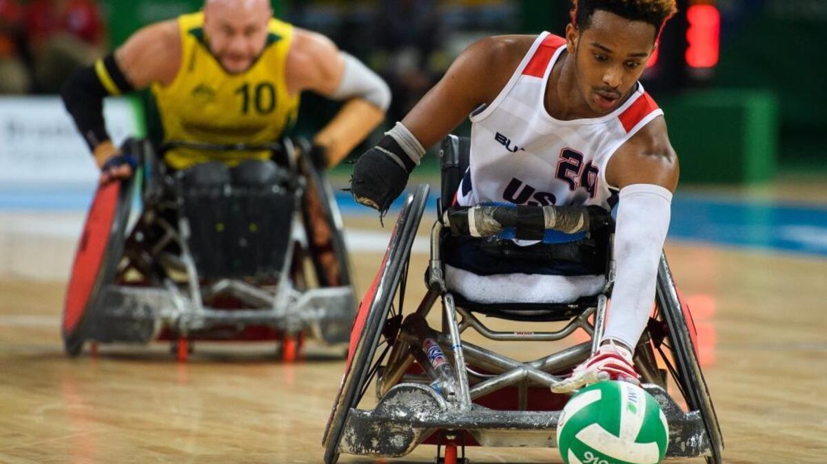 Joshua Brewer of the United States reaches for the ball during the gold medal wheelchair rugby match against Australia at the Paralympics in Rio de Janiero on Sept. 18, 2016.