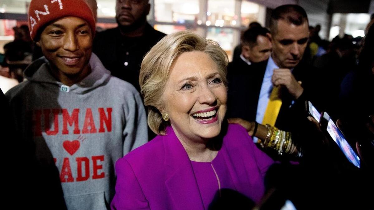 Hillary Clinton, accompanied by singer-songwriter Pharrell Williams, left, greets students at North Carolina Central University on Thursday in Durham, N.C.