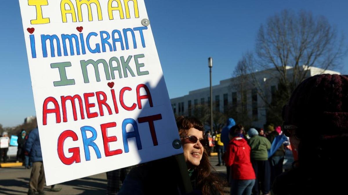 Ellen Furstner, 62, of Marcola, carries a sign during an immigrant rights rally at the Oregon State Capitol in Salem, Ore., on Saturday, Jan. 14, 2017. She immigrated to the United States from Holland as a child.