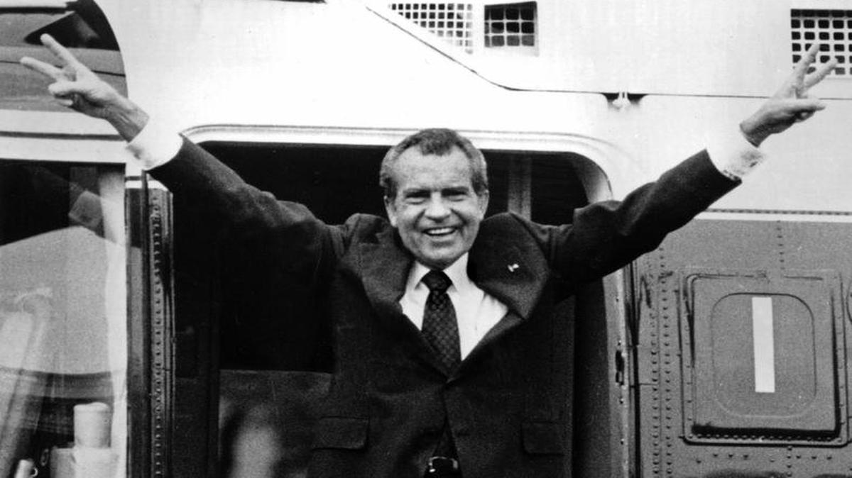 Richard Nixon waves goodbye with a salute to his staff members outside the White House as he boards a helicopter and resigns the presidency on Aug. 9, 1974.