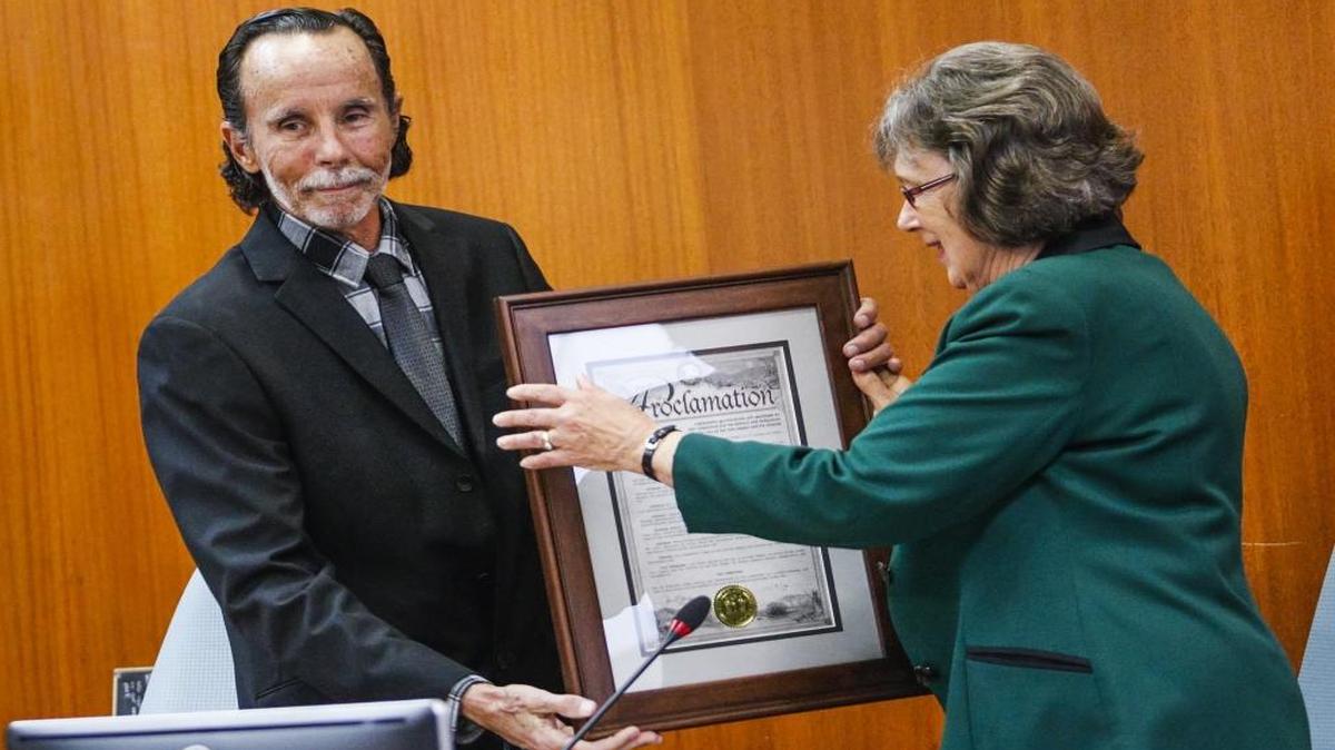 Outgoing San Luis Obispo city council member Dan Carpenter is given a proclamation by mayor Jan Marx during his last council meeting on Dec. 9.