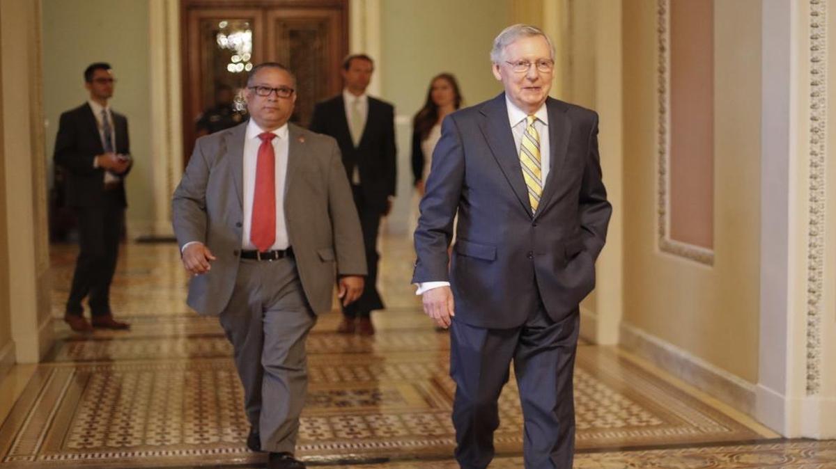 In this July 13, 2017 photo, Senate Majority Leader Mitch McConnell of Ky. walks to his office on Capitol Hill in Washington. Republicansâ€™ latest health care plan would create winners and losers among Americans up and down the income ladder, and across age groups.