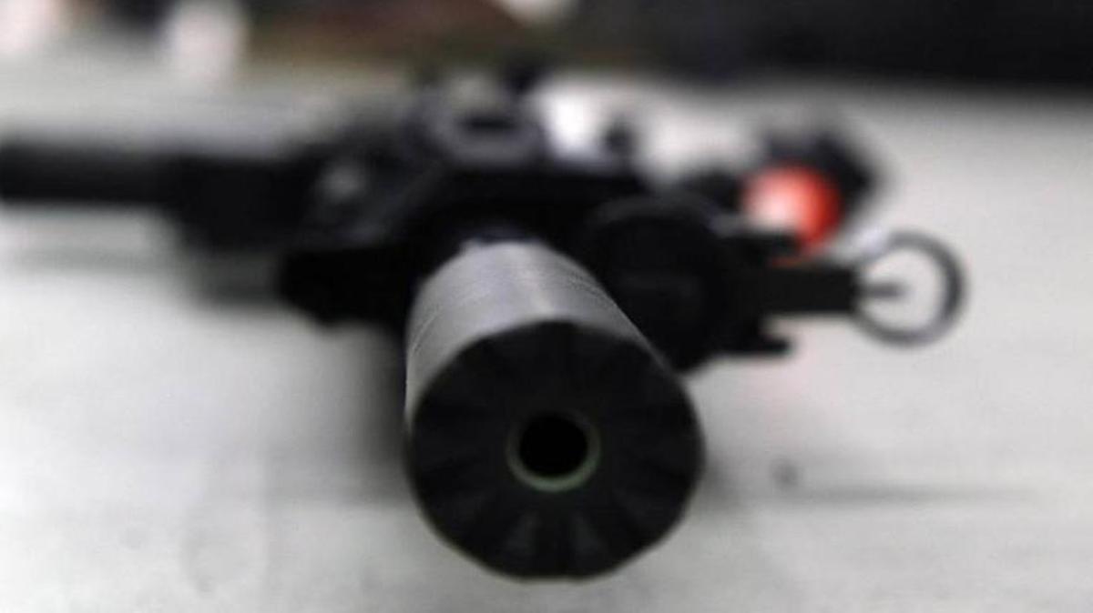 An AR-15 rifle with an attached silencer lies on the floor at a gun range at the NRA headquarters, in Fairfax, Va., on March 20, 2017.