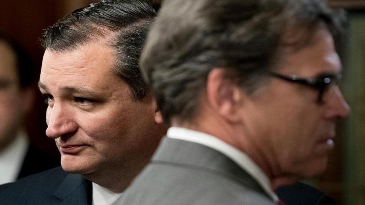 Sen. Ted Cruz, R-Texas, left, and energy secretary nominee Rick Perry, right, stand in the audience before Vice President Mike Pence administers the oath of office to Housing and Urban Development Secretary Ben Carson, Thursday, March 2, 2017, in the Eisenhower Executive Office Building on the White House complex in Washington.