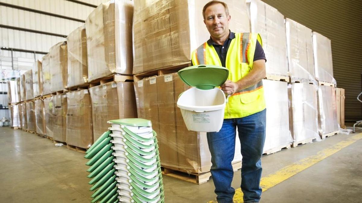 Wast Connections operations supervisor Peter Quaglino stands in front of a stack of boxes containing the new food scrap pails that will soon be distributed to 50,000 homes.