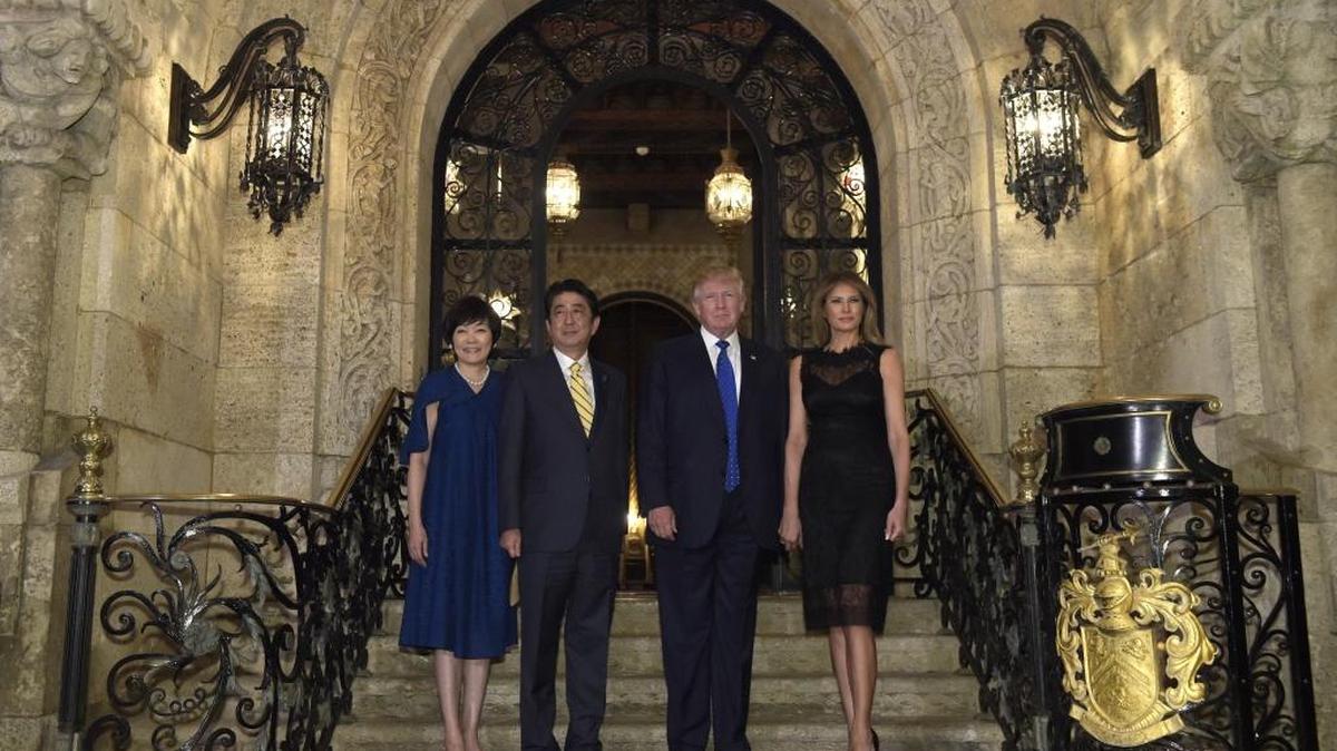 President Donald Trump, second from right, and first lady Melania Trump, right, stop to pose for a photo with Japanese Prime Minister Shinzo Abe, second from left, and his wife Akie Abe, left, before they have dinner at Mar-a-Lago in Palm Beach, Fla., Saturday, Feb. 11, 2017.