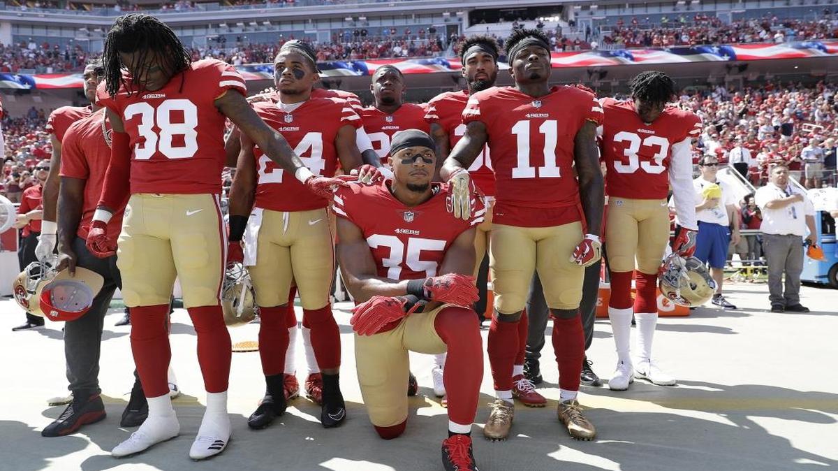 In this Sept. 10, 2017, photo, San Francisco 49ers safety Eric Reid (35) kneels in front of teammates during the national anthem before an NFL football game against the Carolina Panthers in Santa Clara, Calif., Sunday. Reid was an early protester during the national anthem, joining former San Francisco teammate Colin Kaepernick last season.