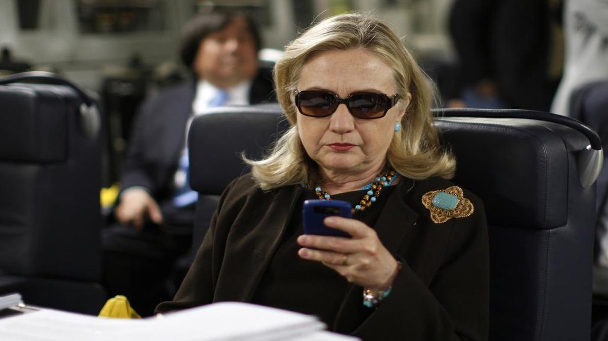Then-Secretary of State Hillary Clinton checks her Blackberry from a desk inside a C-17 military plane upon her departure from Malta, in the Mediterranean Sea, bound for Tripoli, Libya, in 2011. The State Department is reopening an internal investigation of possible mishandling of classified information by Hillary Clinton and top aides.