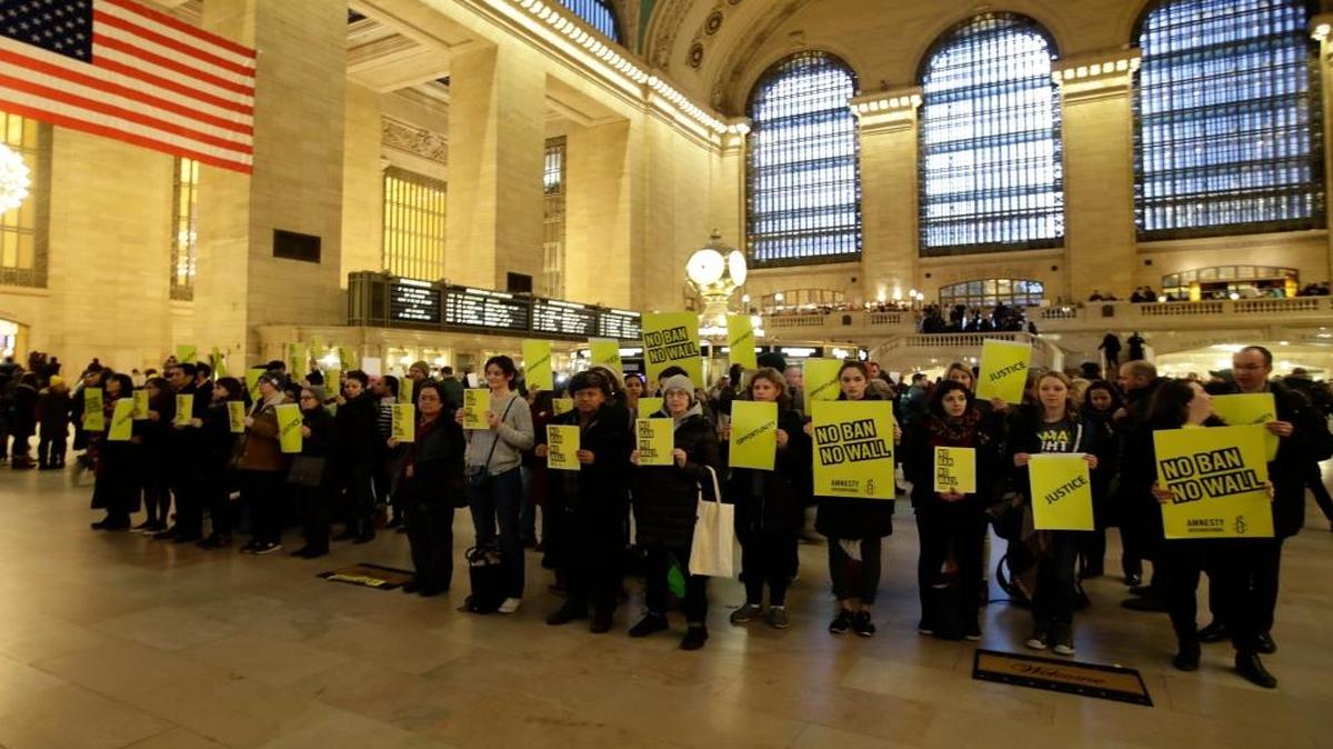 Supporters of Amnesty International gather inside Grand Central Terminal to protest President Donald Trump’s immigration policies Friday, March 3, 2017, in New York.