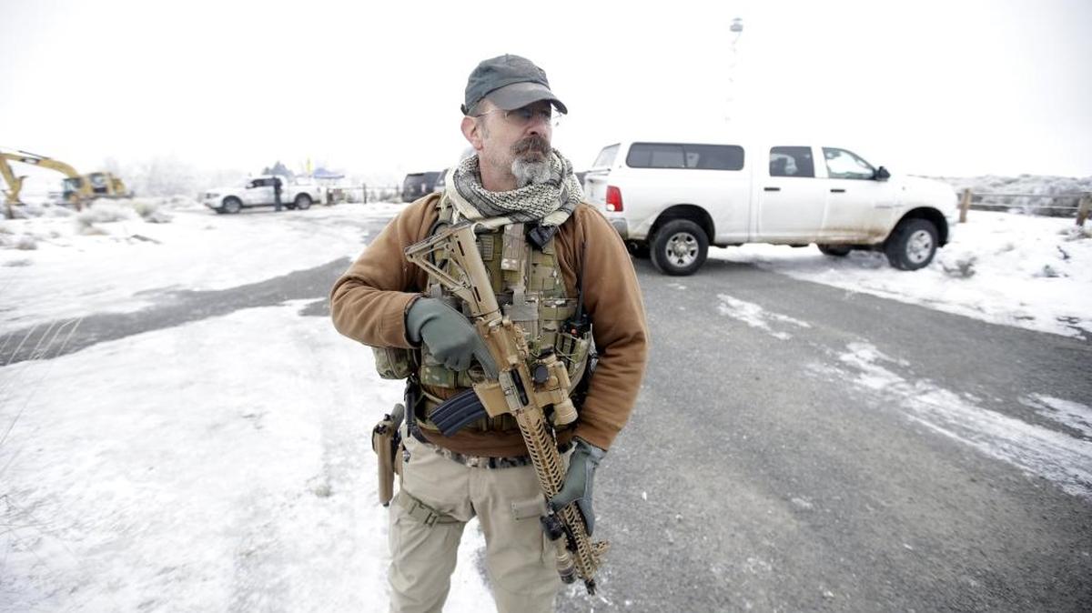 A man stands guard after members of the “3% of Idaho” group along with several other organizations arrived at the Malheur National Wildlife Refuge near Burns, Ore., on Saturday, Jan. 9, 2016. A small, armed group has been occupying the remote national wildlife refuge in Oregon to protest federal land use policies.