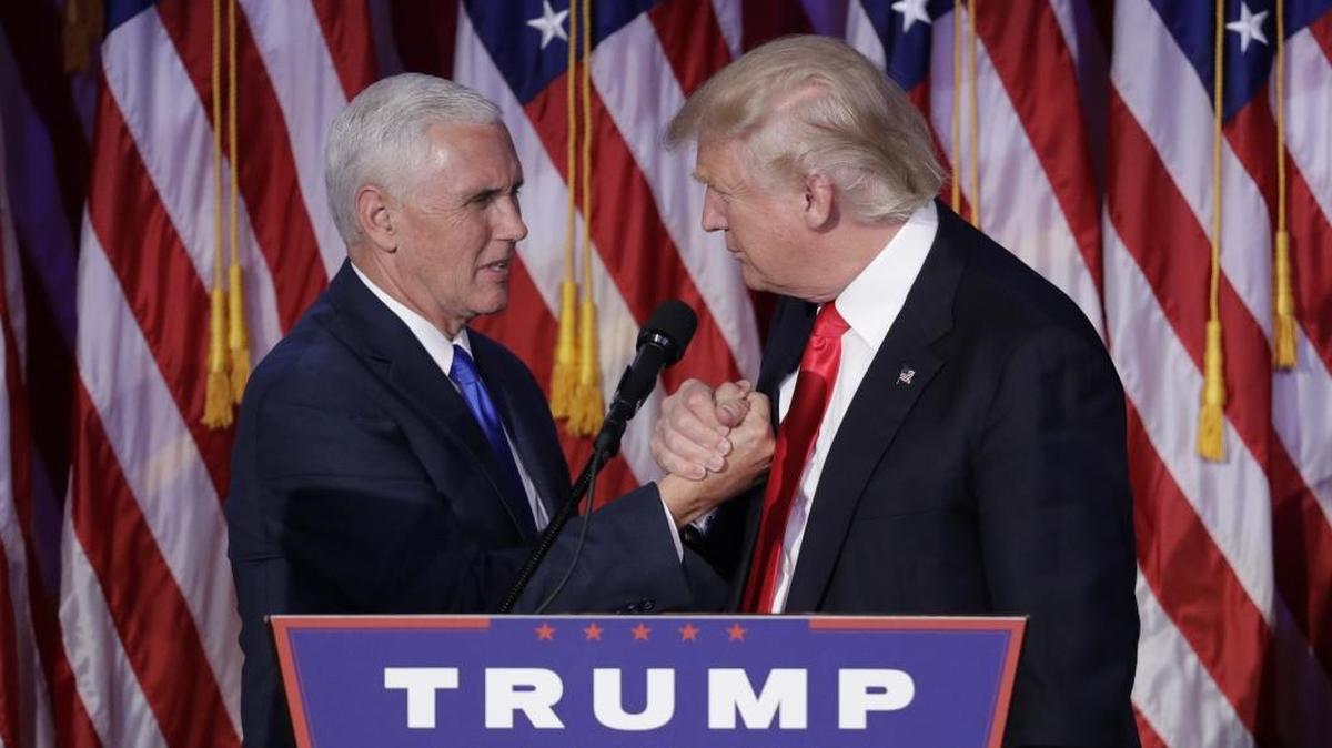 President-elect Donald Trump shakes hands with Vice President-elect Mike Pence as he gives his acceptance speech during his election night rally, Wednesday, Nov. 9, 2016, in New York.