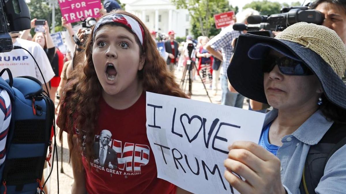 Peyton Price, 14, from La Plata, Md., left, tries to make her point to another person who disagrees with her, during a rally to support President Donald Trump, Saturday, June 3, 2017, in Washington.