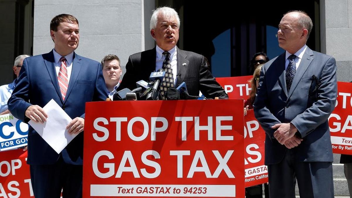Republican gubernatorial candidate John Cox, center, blasts a recent gas tax increase during a news conference June 18, 2018, in Sacramento. Cox is the chairman of a campaign to repeal the gas tax increase and faces Democratic Lt. Gov. Gavin Newsom in November. Cox is flanked by Carl DeMaio, left, chairman of Reform California, and Jon Coupal, right, president of the Howard Jarvis Taxpayers Association.