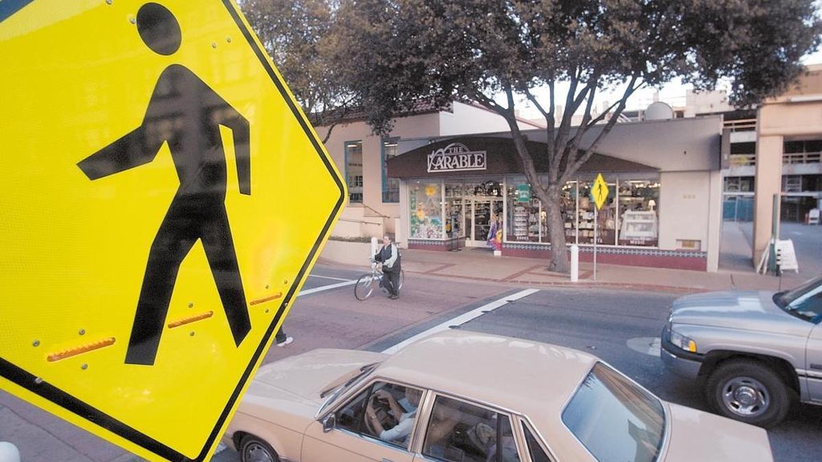 Pedestrians use the crosswalk to the Downtown Centere in San Luis Obispo on Marsh Street.