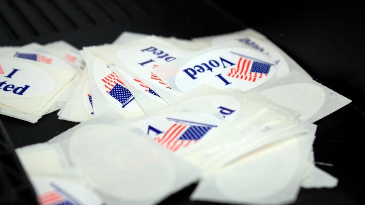 Voter stickers sit in a pile near a ballot machine at an early voting site in Albuquerque, N.M., on Thursday.