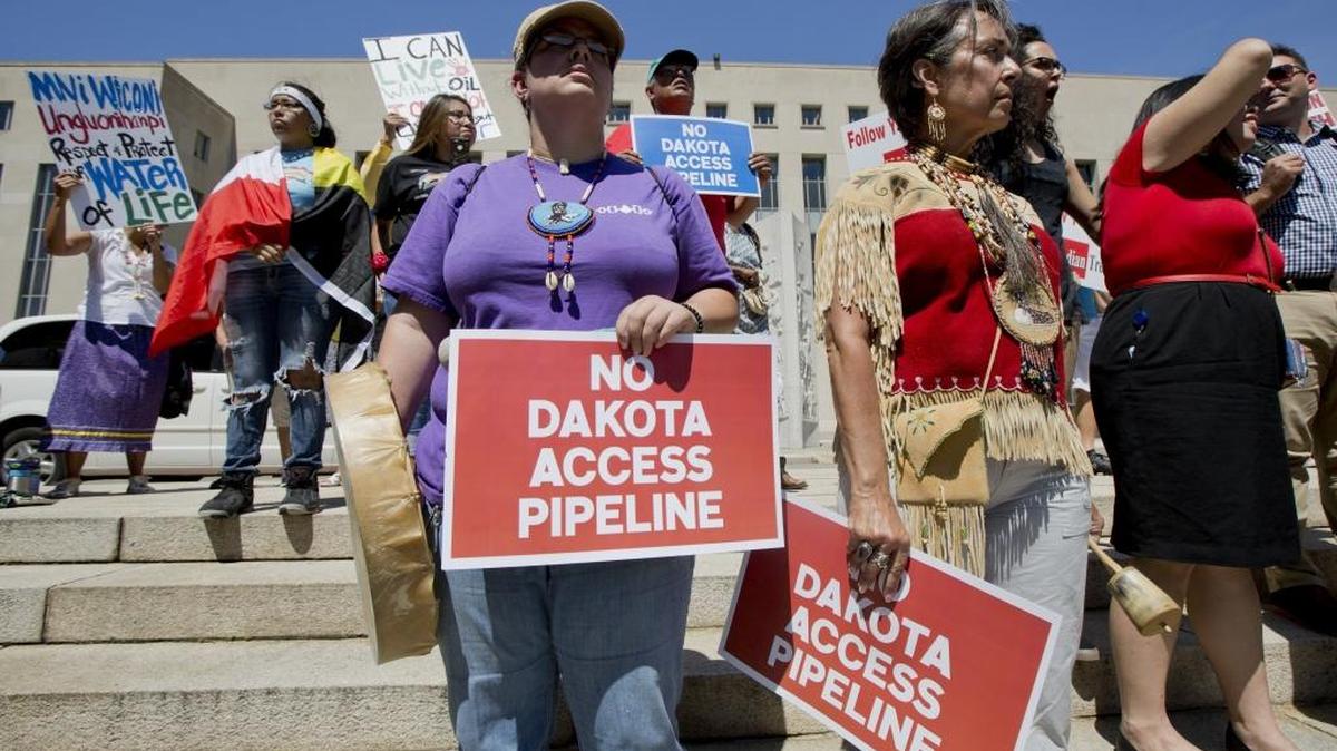 Grace Caisson Miller right, a member of the Mi’kmaq Tribe, and Maureen Zieber of the Nanticoke Oneida Tribe, left, join a rally outside the U.S. District Court in Washington on Wednesday, Aug. 24, 2016, in solidarity with the Standing Rock Sioux Tribe in their lawsuit against the Army Corps of Engineers to protect their water and land from the Dakota Access Pipeline.
