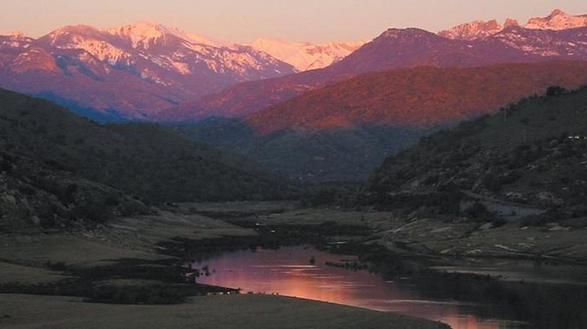 Kaweah Lake reflects the Sierra Nevada at sunset.