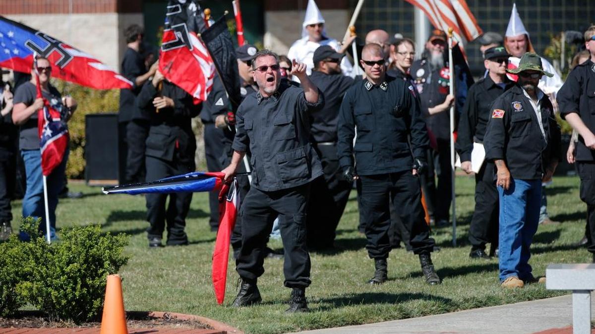 In this April 23, 2016 photo, members of the Ku Klux Klan participate in a “white pride” rally in Rome, Ga. Klan leaders say they feel that U.S. politics are going their way, as a nationalist, us-against-them mentality deepens across the nation.