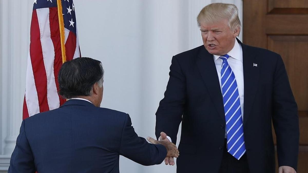 President-elect Donald Trump greets Mitt Romney as he arrives at Trump National Golf Club Bedminster clubhouse in Bedminster, N.J., Saturday, Nov. 19, 2016.