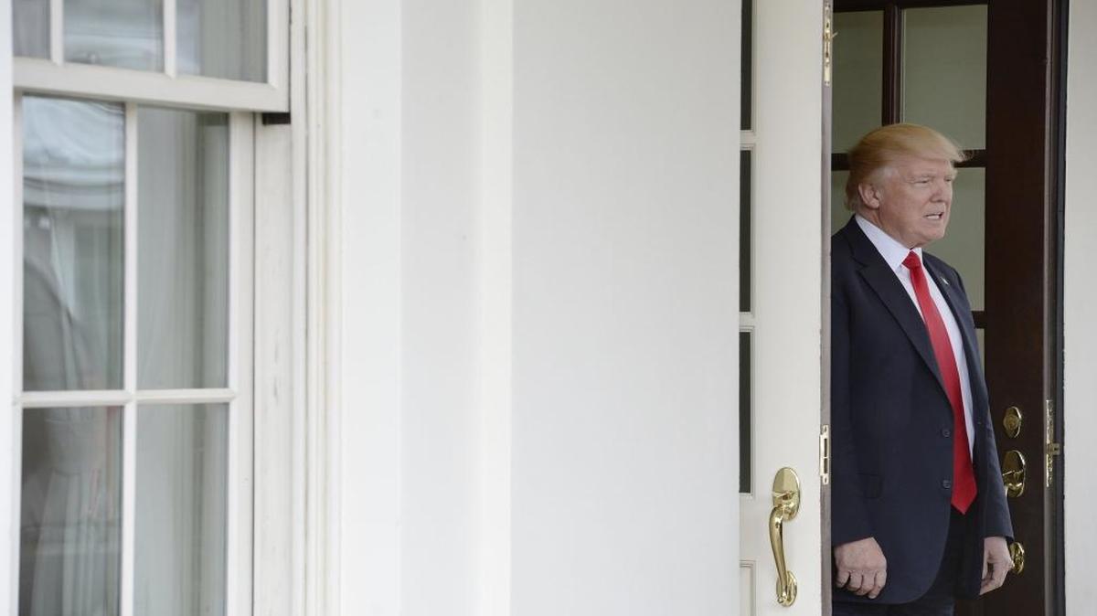 U.S. President Donald Trump waits for Prime Minister Lokke Rasmussen of Denmark outside the West Wing of the White House on March 30, 2017 in Washington, D.C.