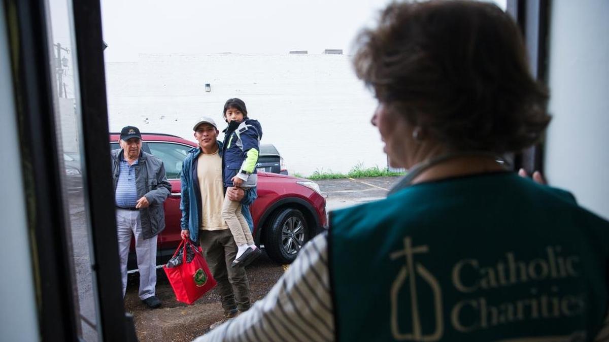 In a Thursday, June 22, 2018 photo, father and daughter are provided transport to the airport from the Catholic Charities Humanitarian Respite Center, in McAllen, Texas. The families were processed and released by U.S. Customs and Border Protection, and then taken to the center, where they were provided with clean clothes, a shower and meal before embarking to their final destinations.