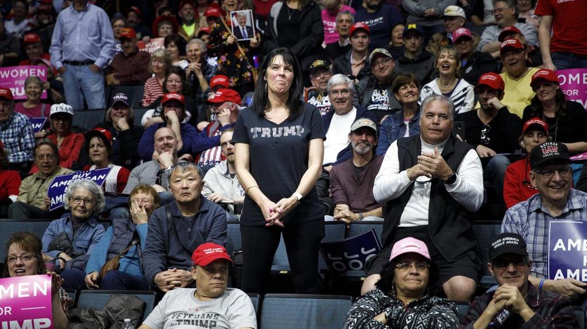 Attendees watch as President Donald Trump delivers remarks during his rally in Van Andel Arena in Grand Rapids, Michigan, on March 28, 2019.