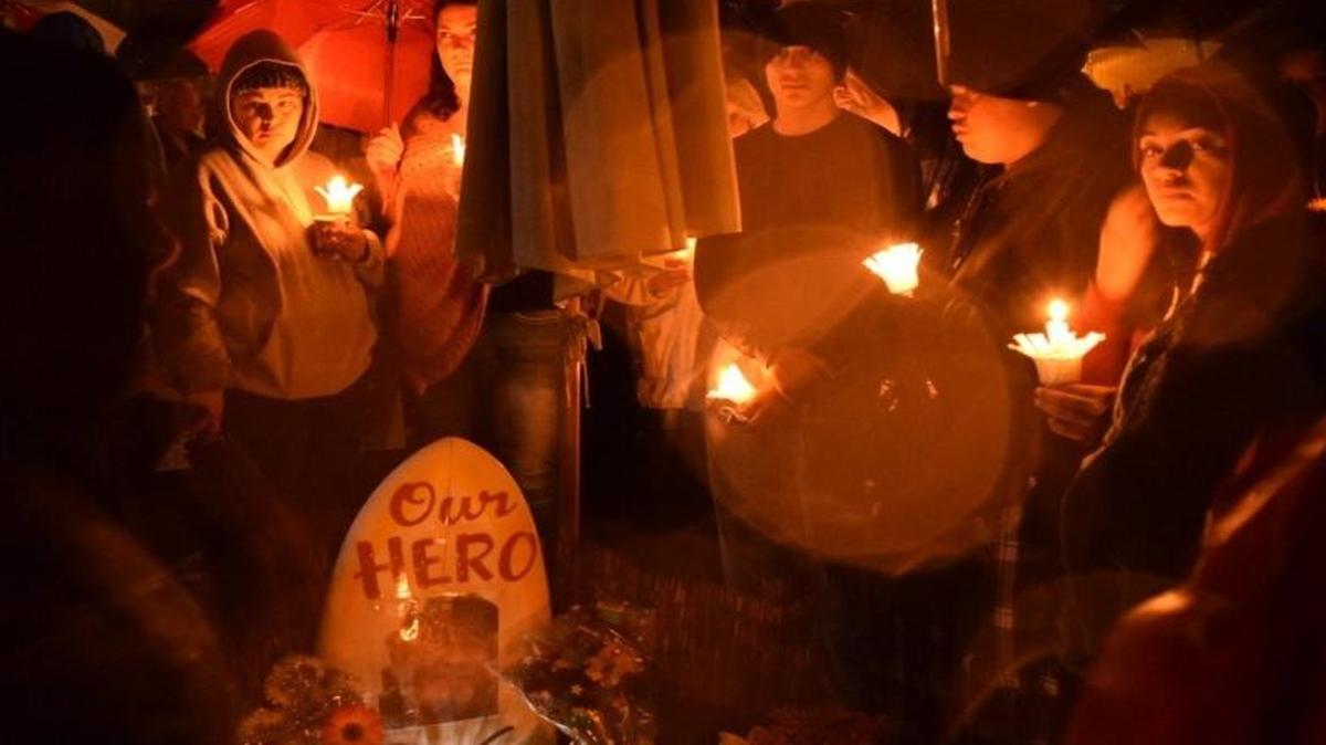 Mourners came out in the rain Dec. 23 to attend a vigil in memory of David Fear, a Grover Beach man who suffered fatal injuries while trying to rescue his neighbor from a dog attack on Dec. 13. The sidewalk vigil was held on Nacimiento Avenue where Fear lived.