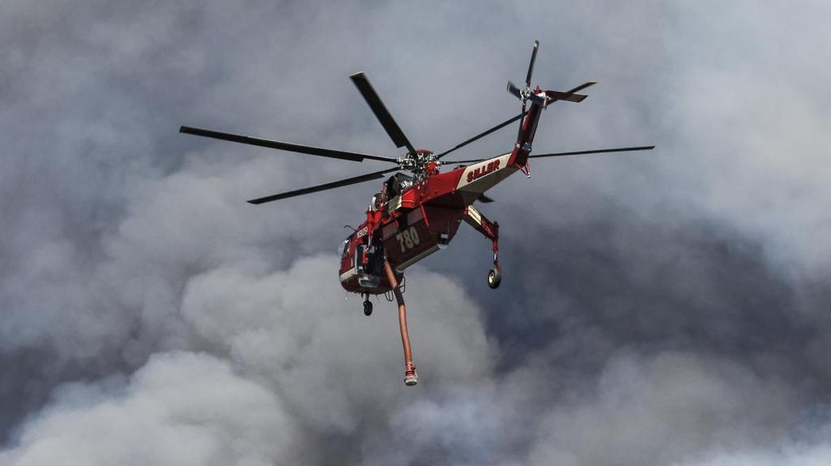San Luis Obispo airport dictates the flight plan for helicopters, mostly heading down Broad Street, then making a left turn before returning to the airport. Here, a fire attack helicopter prepares to drop water on the southwestern front of the Chimney Fire.