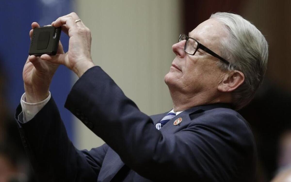 State Sen. Bill Monning, D-Carmel, snaps a photo as the votes are posted for a transportation bill, Thursday, April 6, 2017, in Sacramento. The Senate approved SB1, a $5-billion-a-year plan to boost California's gas and vehicle taxes to pay for major road repairs. The bill was sent to the Assembly for a vote.