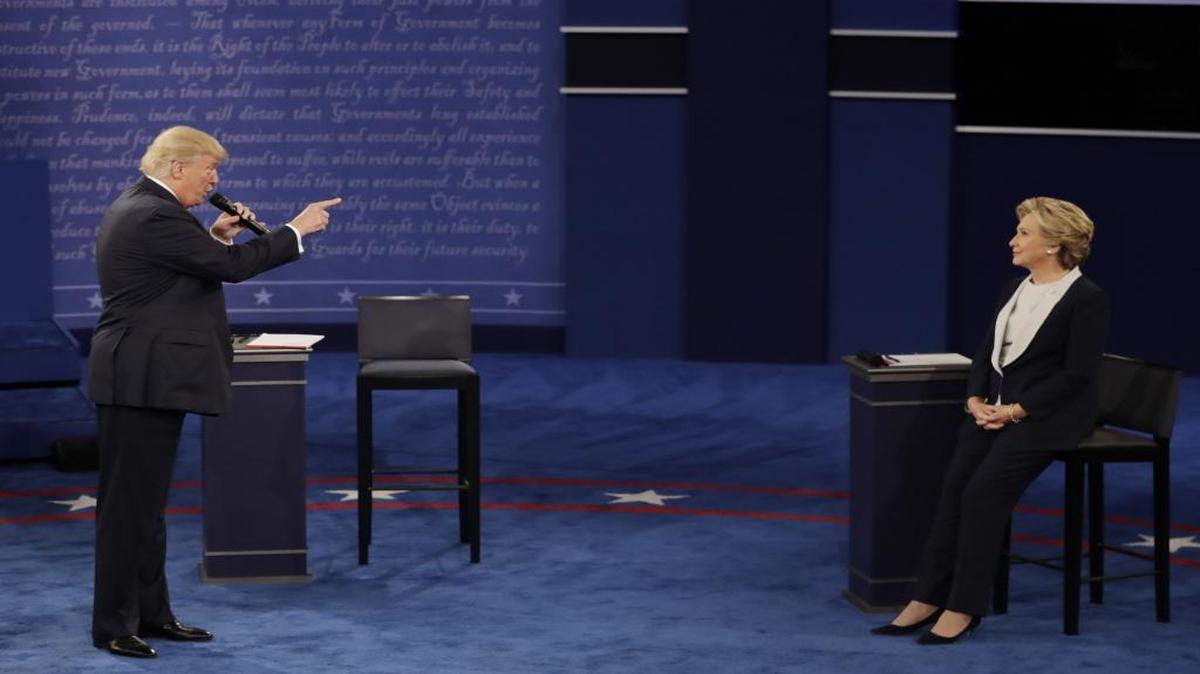 Republican presidential nominee Donald Trump speaks to Democratic presidential nominee Hillary Clinton during the second presidential debate at Washington University in St. Louis, on Oct. 9, 2016.