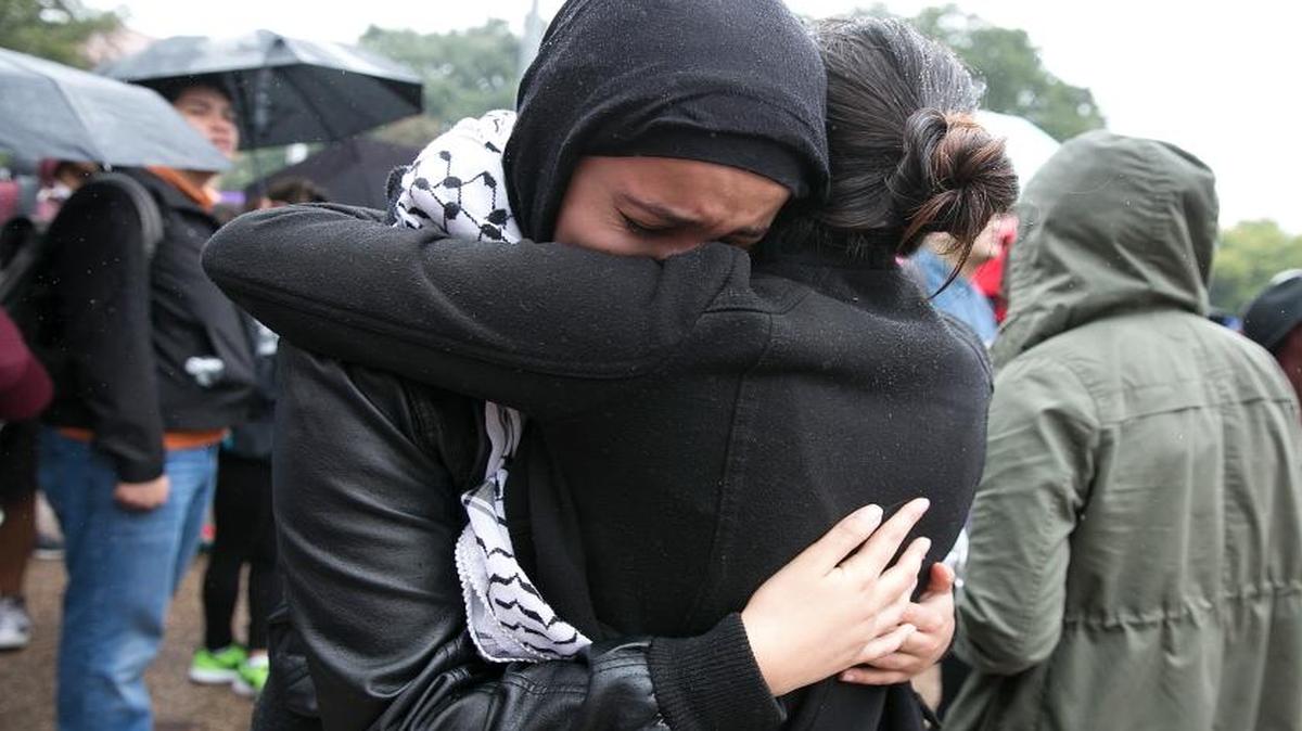 Noor Wadi, a second year law student, cries as she hugs a friend after speaking with fellow students gathered at the University of Texas at Austin to protest the Trump election on Wednesday.