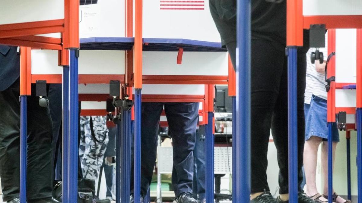 Voters fill out their ballots as early voting begins statewide Wednesday in Cincinnati.