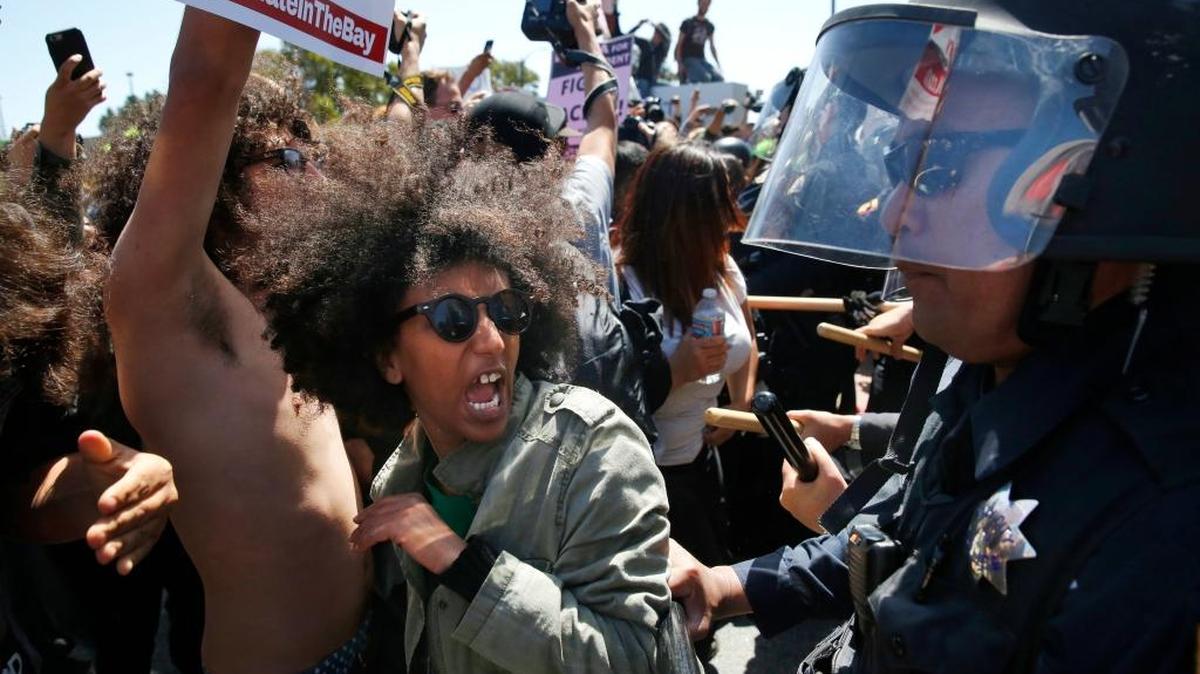 Biseat Yawkal, an Oakland protester, yells as she is pushed by police trying to push protesters back outside of the Hyatt Regency during the first day of the California Republican Party Convention in Burlingame on April 29. The convention featured speeches from Presidential candidates Donald Trump and John Kasich among others.