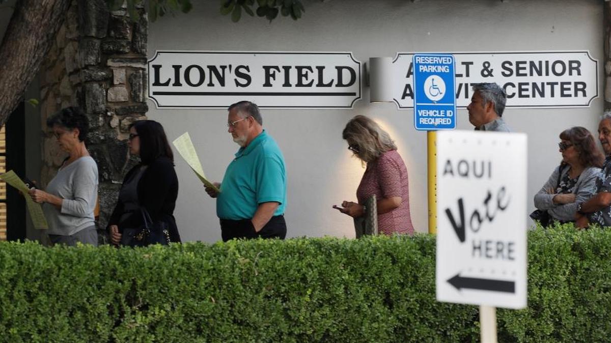 Voters stand in line Oct. 24 at an early polling site in San Antonio.