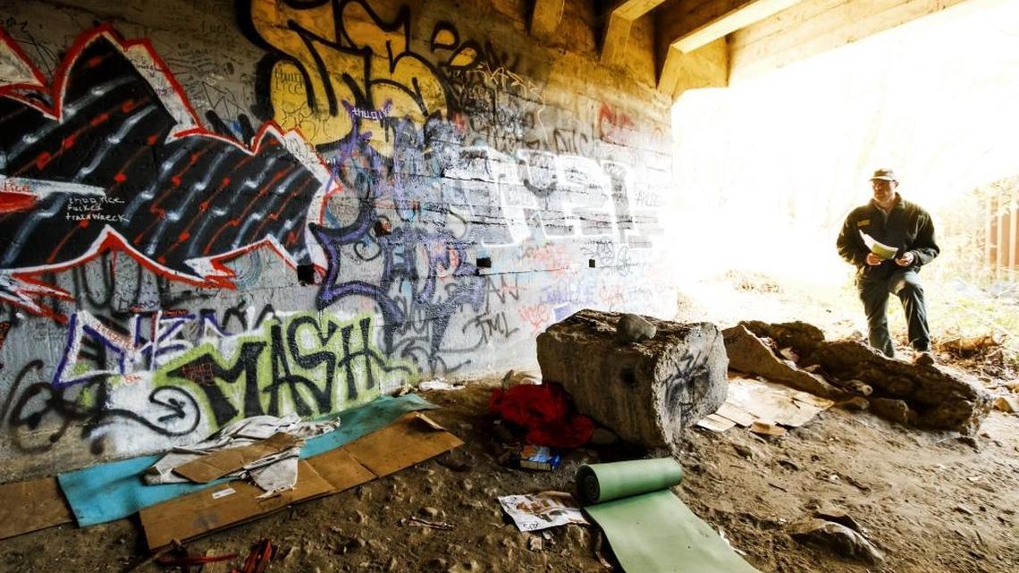 Ranger services supervisor Doug Carscaden visits an area of the San Luis Creek frequented by the homeless in December 2015 to warn them of the dangers they could face with the heavy rains expected during the winter.